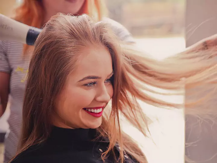 A woman having her hair blow died