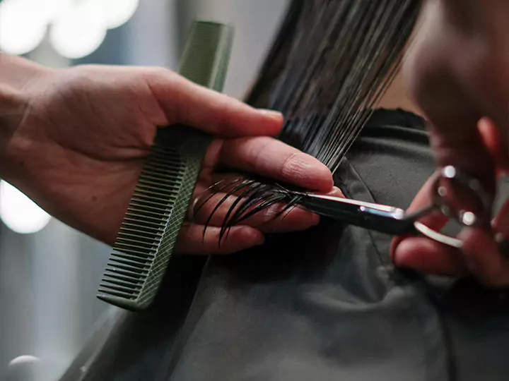 A woman having her hair cut